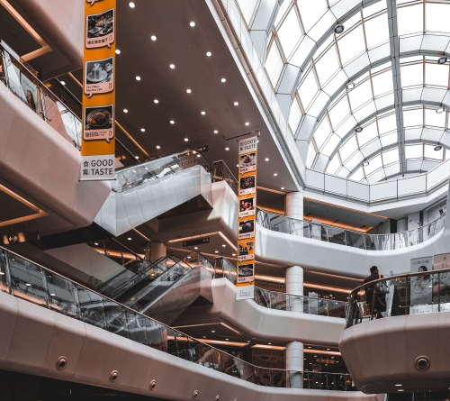 Indoor mall area with escalators and a full span skylight.